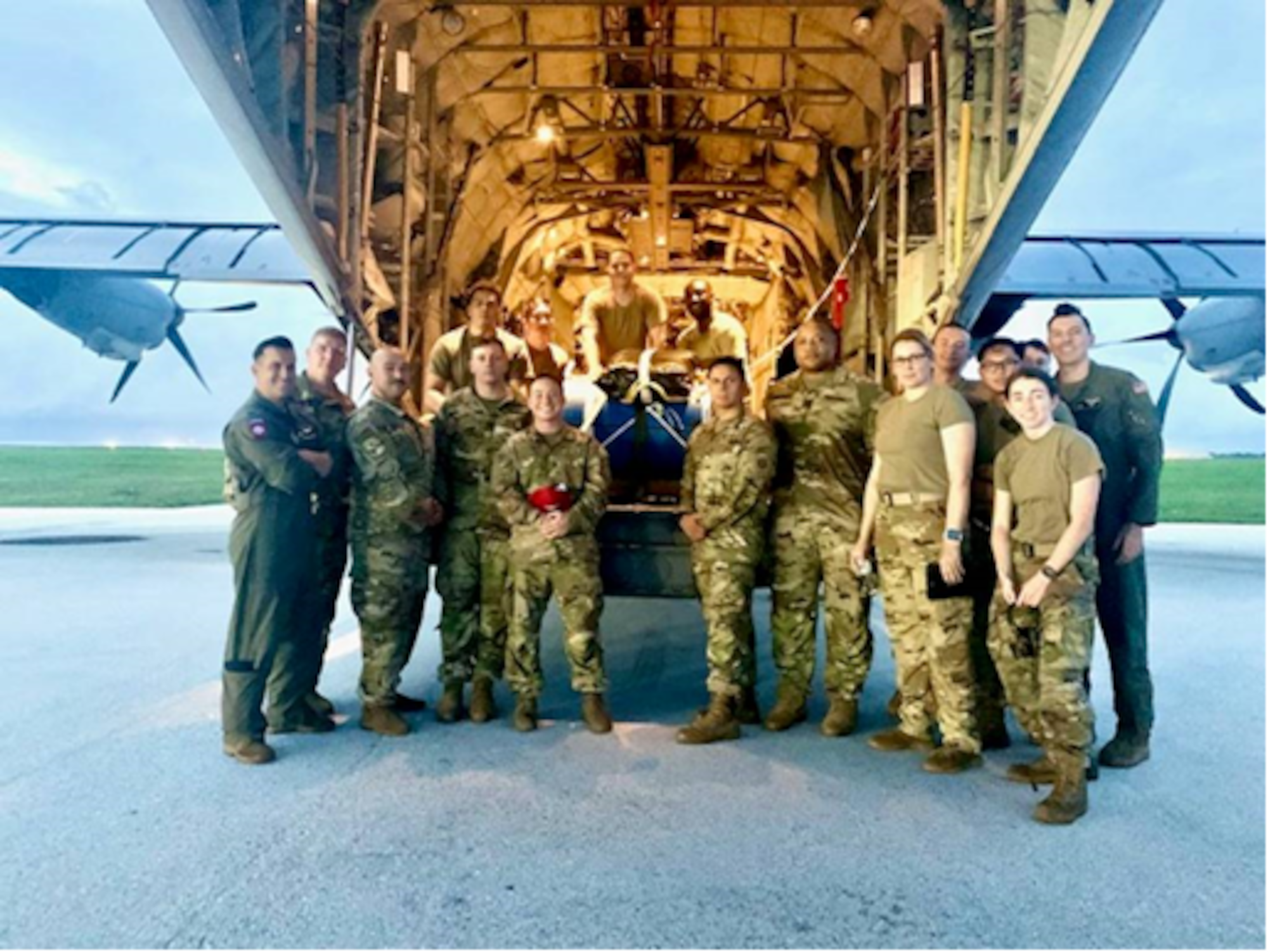 A team of U.S. Air Force Airmen pose for a group photo outside a U.S. Air Force C-130J Super Hercules, call sign “KANTO 92,” assigned to 36th Airlift Squadron deployed from Yokota Air Force Base, Japan, after completing a rescue mission at Andersen Air Force Base, Guam, July 25, 2021. Members of the U.S. Air Force, U.S. Navy, U.S. Coast Guard worked together to save a U.S. Army Soldier who sustained injuries while on an Army Watercraft System during Exercise Forager 21.