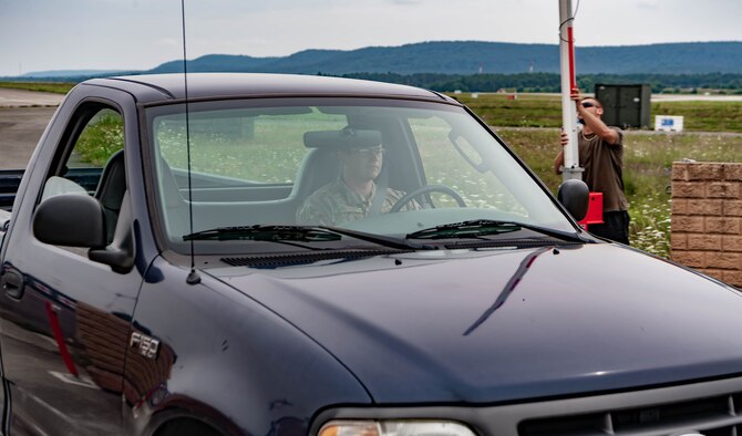 U.S. Air Force Senior Airman James Jones, a controlled movement area escort and project manager assigned to the 86th Civil Engineering Squadron,  talks to an escort augmentee at a construction site at Ramstein Air Base, Germany, July 27, 2021. Escort workers make sure that the contractors do not cross over restricted area lines and stay away from certain areas when planes are landing for security and safety of everyone on the airfield. 
(U.S. Air Force photo by Airman Jared Lovett)