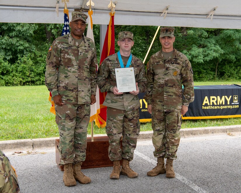 three soldiers posing for a photo in front of flags.