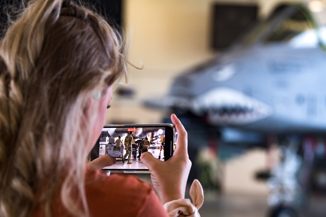 Photo of Airman recording with their phone