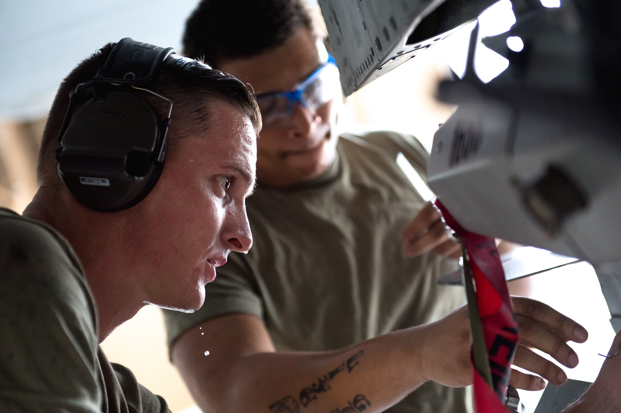 Photo of Airmen working on aircraft