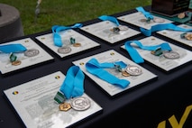medals and awards laid out on a table.