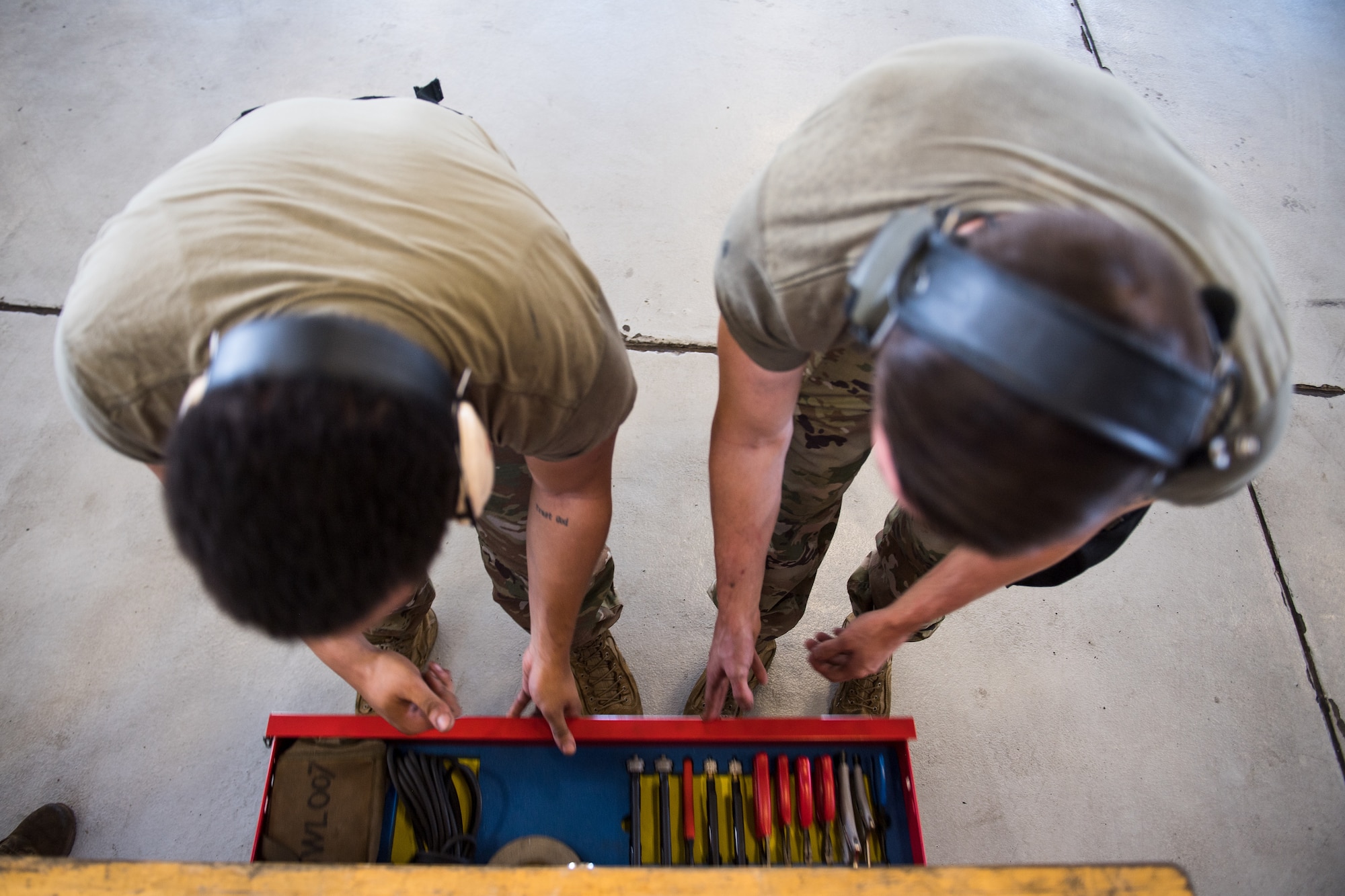 Photo of Airmen sorting tool box