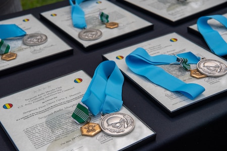 medals and awards laid out on a table.