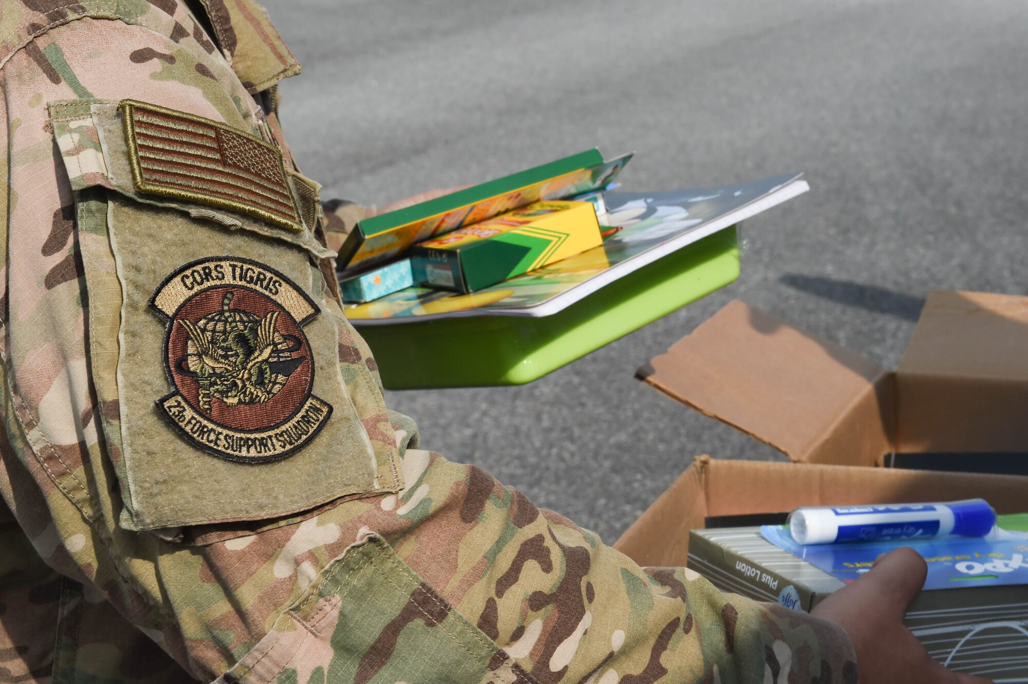 U.S. Air Force Tech. Sgt. Jeremy Kanapaux, 23rd Force Support Squadron readiness non-commissioned officer, gathers school supplies during an event supporting Operation Homefront at Moody Air Force Base, Georgia, July 26, 2021. Volunteers and event coordinators handed out 192 bags of school supplies to Airmen, E-6 and below. (U.S. Air Force photo by Senior Airman Rebeckah Medeiros)