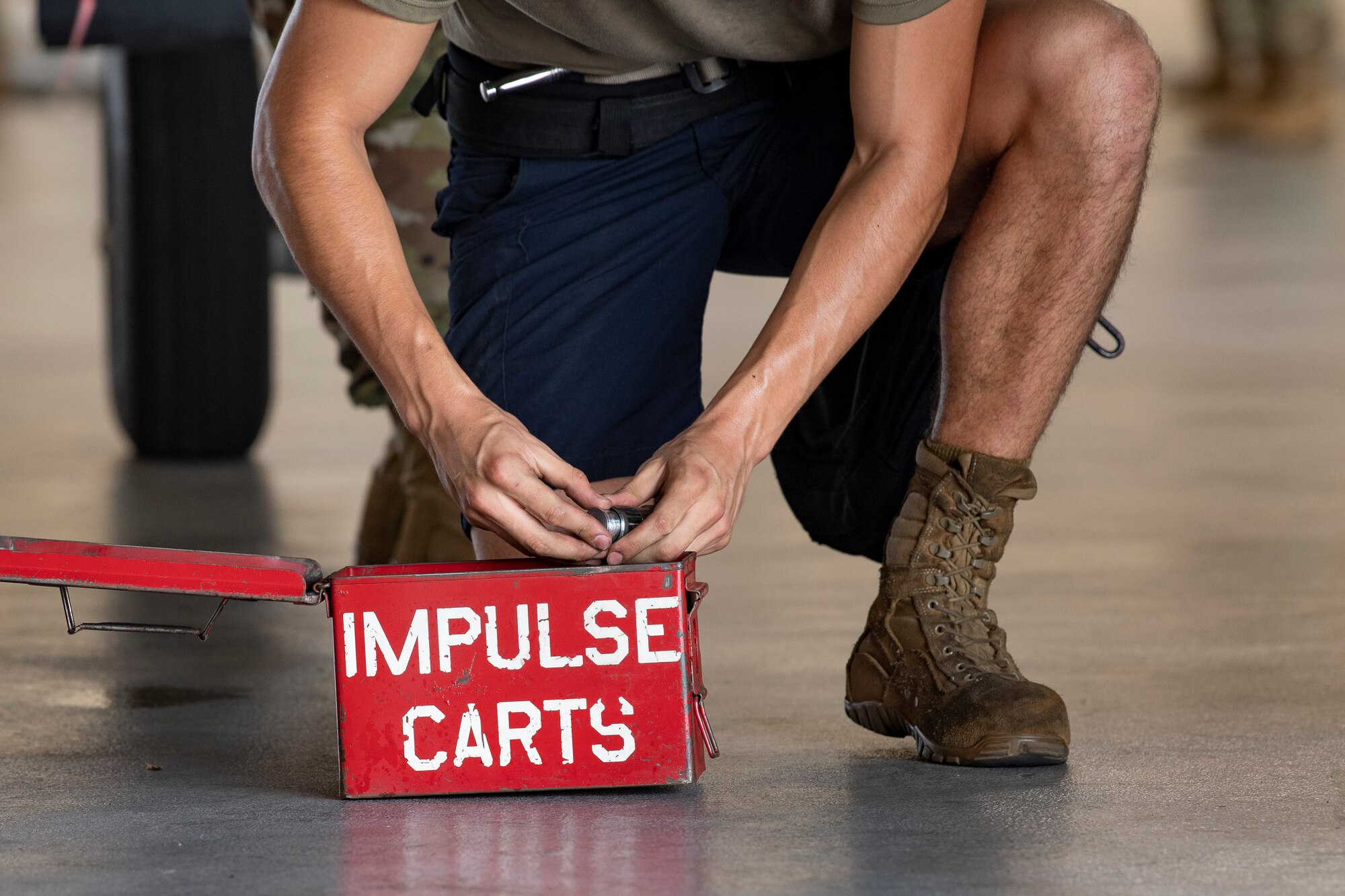 Photo of Airman handling munitions parts