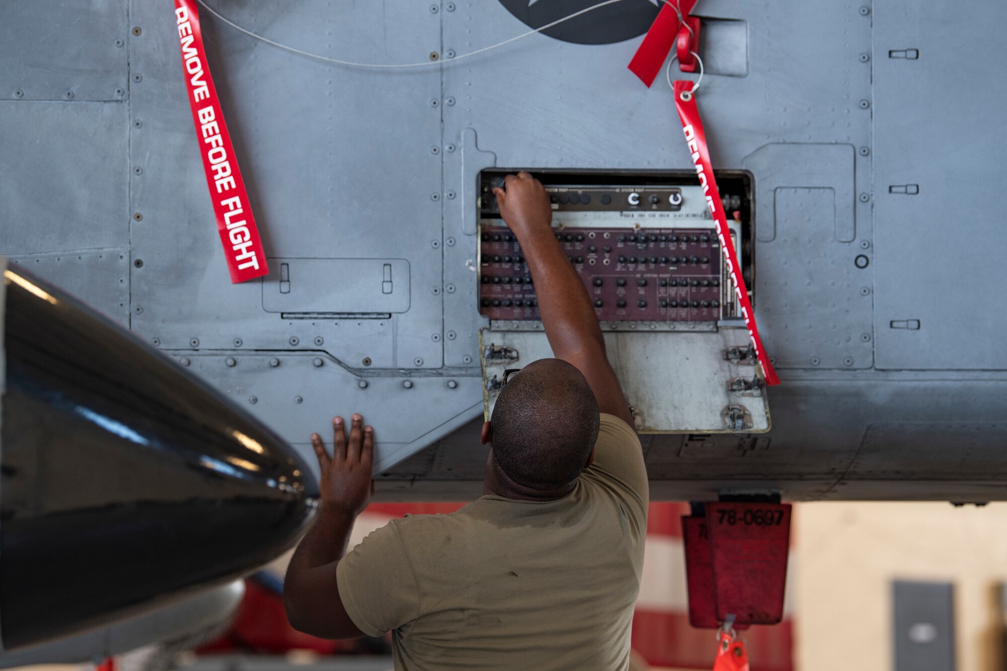 Photo of Airman working on aircraft