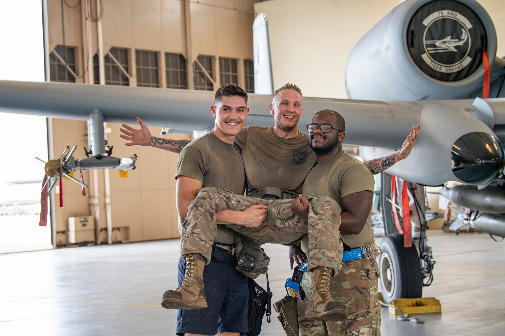 Photo of Airmen in front of aircraft