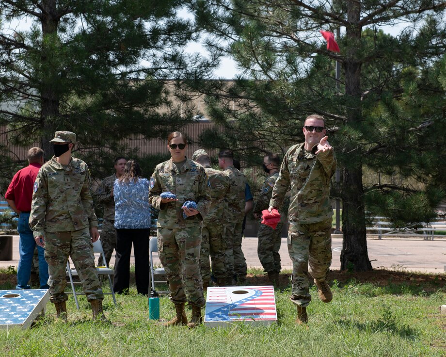 People play cornhole.