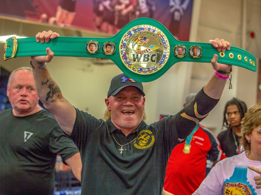 Joe Higgins, head coach of the II Marine Expeditionary Force, Martial Arts Center of Excellence, raises the Team Belt at the Christy Martin’s Title Boxing Invitational, Fayetteville, N.C., July 25, 2021. The Christy Martin’s Title Boxing Invitational, named after the 2019 International Hall of Famer, attracted elite fighters from across the eastern Carolinas. The II MEF MACE achieved five weight-class championships and won the overall Team Belt. (U.S. Marine Corps photo by Lance Cpl. Eric Ramirez)