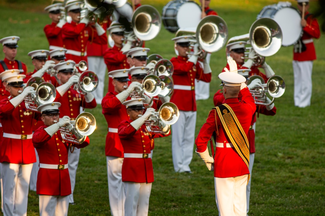 Marines with “The Commandant’s Own,” U.S. Marine Drum and Bugle Corps, perform during the Non-Commissioned Officer Tuesday Sunset Parade at the Marine Corps War Memorial, Arlington, Va., July 27, 2021. The hosting official for the evening was Sgt. Maj. Troy E. Black, Sergeant Major of the Marine Corps, and the guest of honor was Ms. Melissa Cohen, Director, Department of the Navy Sexual Assault Prevention and Response Office. (U.S. Marine Corps photo by Lance Cpl. Tanner Lambert)