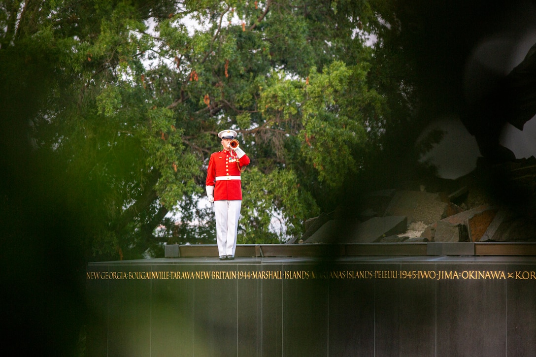 Staff Sgt. Christopher Walker, ceremonial bugler with “The Commandant’s Own,” U.S. Marine Drum and Bugle Corps, plays “Taps” during the Non-Commissioned Officer Tuesday Sunset Parade at the Marine Corps War Memorial, Arlington, Va., July 27, 2021. The hosting official for the evening was Sgt. Maj. Troy E. Black, Sergeant Major of the Marine Corps, and the guest of honor was Ms. Melissa Cohen, Director, Department of the Navy Sexual Assault Prevention and Response Office. (U.S. Marine Corps photo by Lance Cpl. Tanner Lambert)