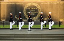 Marines with the parade staff march into position during the Non-Commissioned Officer Tuesday Sunset Parade at the Marine Corps War Memorial, Arlington, Va., July 27, 2021.