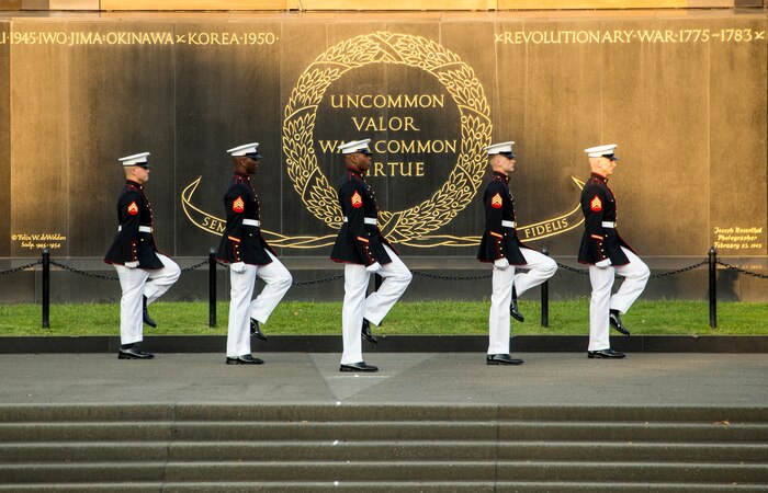 Marines with the parade staff march into position during the Non-Commissioned Officer Tuesday Sunset Parade at the Marine Corps War Memorial, Arlington, Va., July 27, 2021.