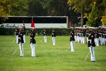 Marines with Marine Barracks Washington stand at the position of attention during the Non-Commissioned Officer Tuesday Sunset Parade at the Marine Corps War Memorial, Arlington, Va., July 27, 2021.