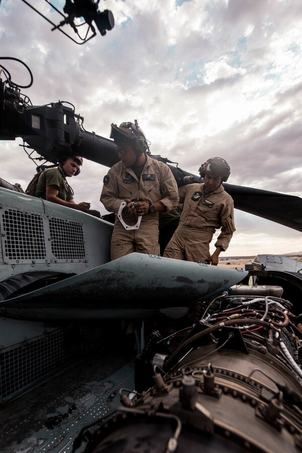 Marines with Marine Heavy Helicopter Squadron (HMH) 772 perform maintenance on a CH-53E Super Stallion helicopter during Integrated Training Exercise (ITX) 4-21 at Marine Corps Air Ground Combat Center, Twentynine Palms, California on July 28, 2021. HMH-772 is supporting Marine Air Ground Task Force 25 as part of the Aviation Combat Element during ITX, providing troop transport and heavy lift capabilities. (U.S Marine Corps photo by Lance Cpl. David Intriago)