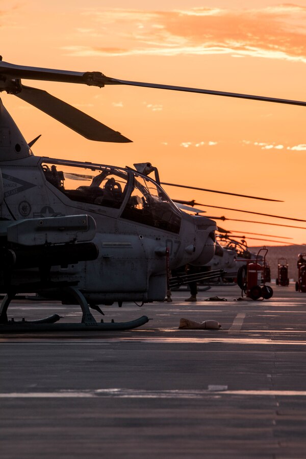 The sun sets on Marine Light Attack Helicopter Squadron (HMLA) 773's flight line during Integrated Training Exercise (ITX) 4-21 at Marine Corps Air Ground Combat Center Twentynine Palms, California on July 28, 2021. HMLA-773 is supporting Marine Air Ground Task Force 25 as part of the Aviation Combat Element during ITX, providing close air support and deep air support to the Ground Combat Element. (U.S Marine Corps photo by Lance Cpl. David Intriago)
