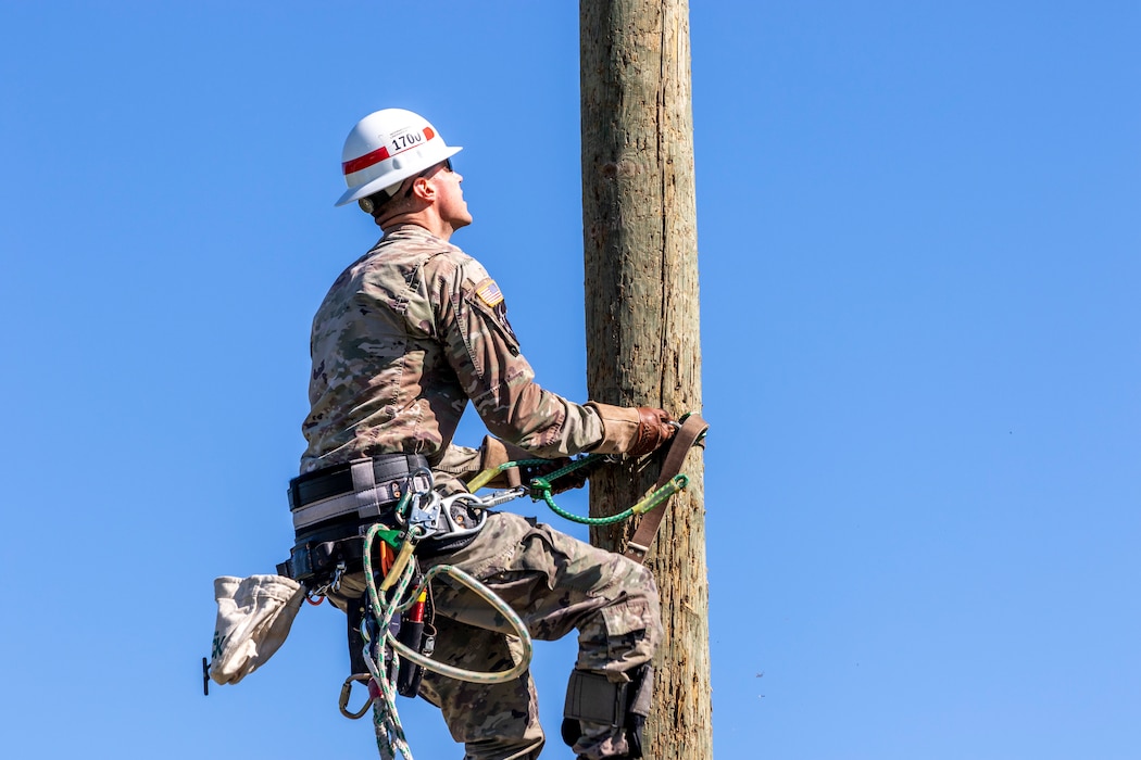 Staff Sgt. Sean Moody, with the 249th Engineer Battalion, Prime Power, ascends a power pole during a training exercise at Fort Belvoir, Virginia