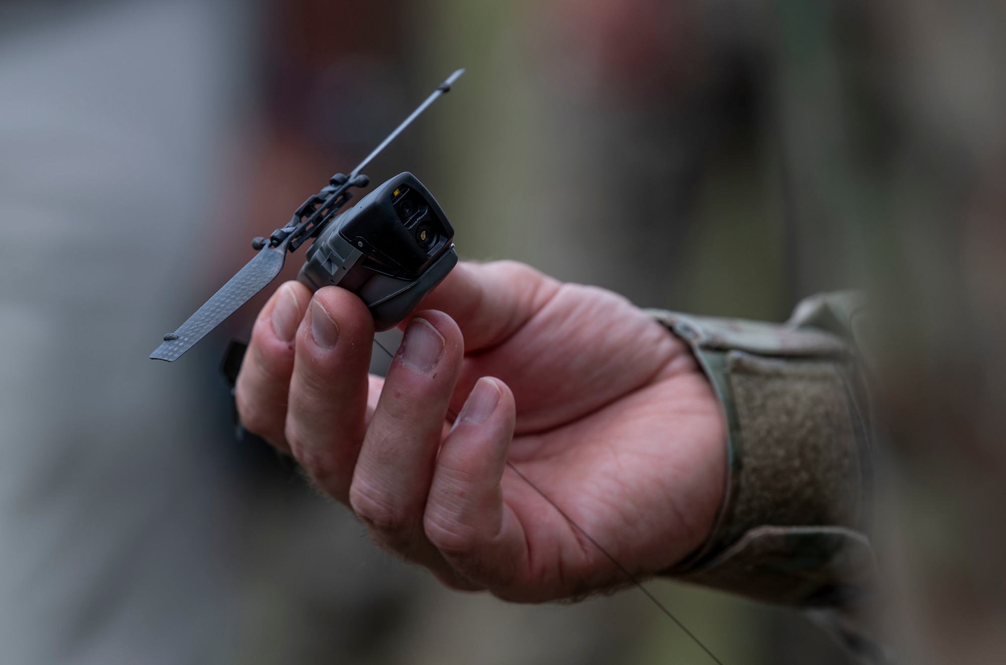 A black hornet nano unmanned aerial vehicle is displayed during the Air Force Special Operations Command Technology, Acquisition, and Sustainment Review at Austere Field #6, Florida, July 21, 2021.