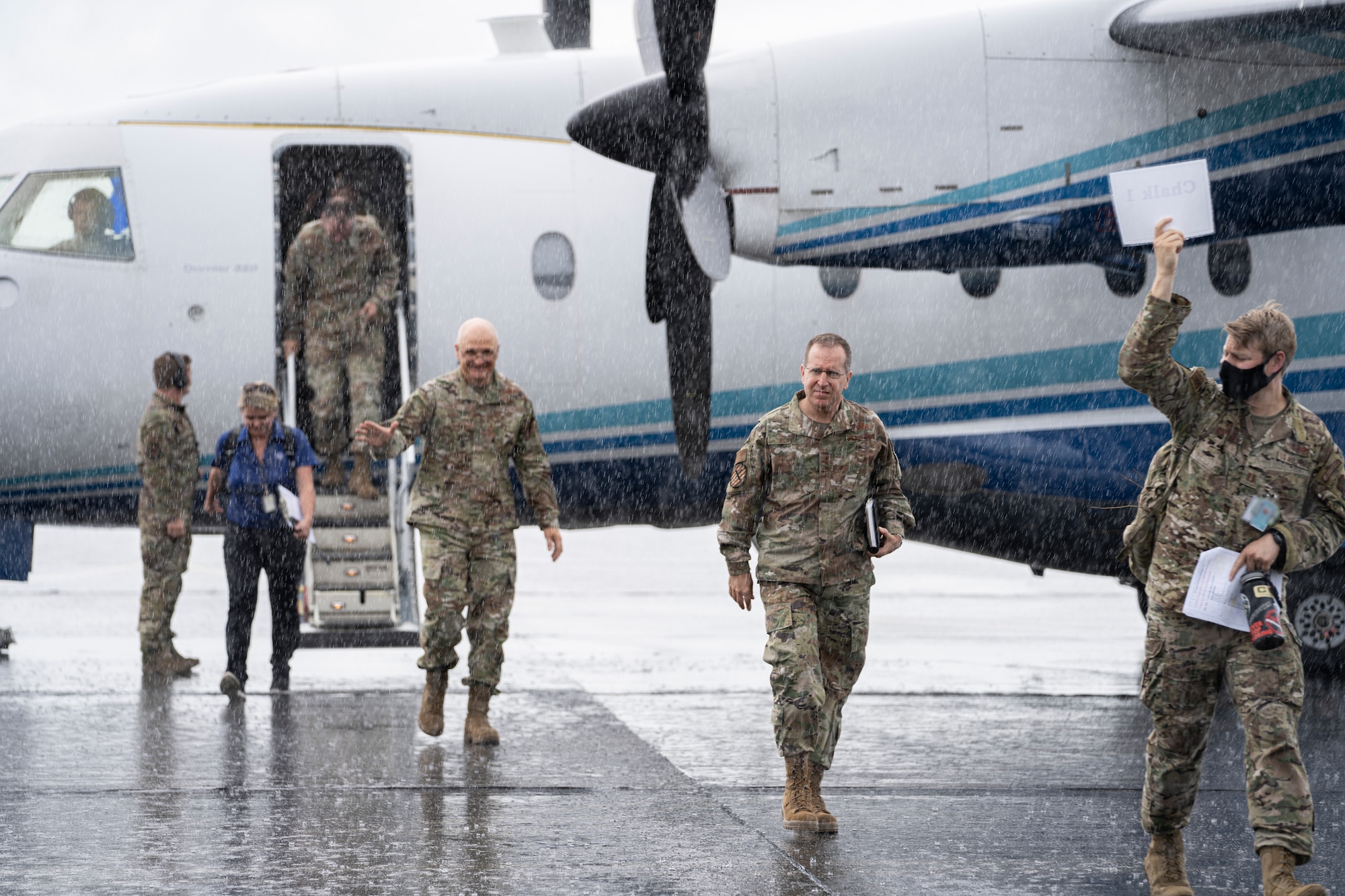 Gen. Arnold Bunch Jr., Air Force Materiel Command commander, left, and Lt. Gen. Jim Slife, Air Force Special Operations Command commander exit a C-146A Wolfhound with other visitors at Duke Field, Florida, July 21, 2021.