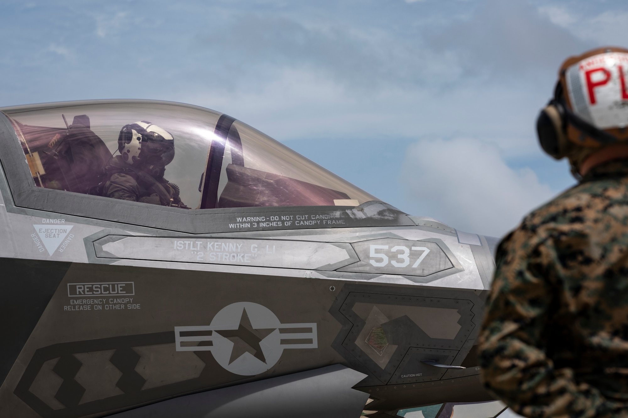 Two U.S. Marines prepare to launch an F-35B Lightning II during a forward arming and refueling point demonstration at Duke Field, Florida, July 21, 2021.