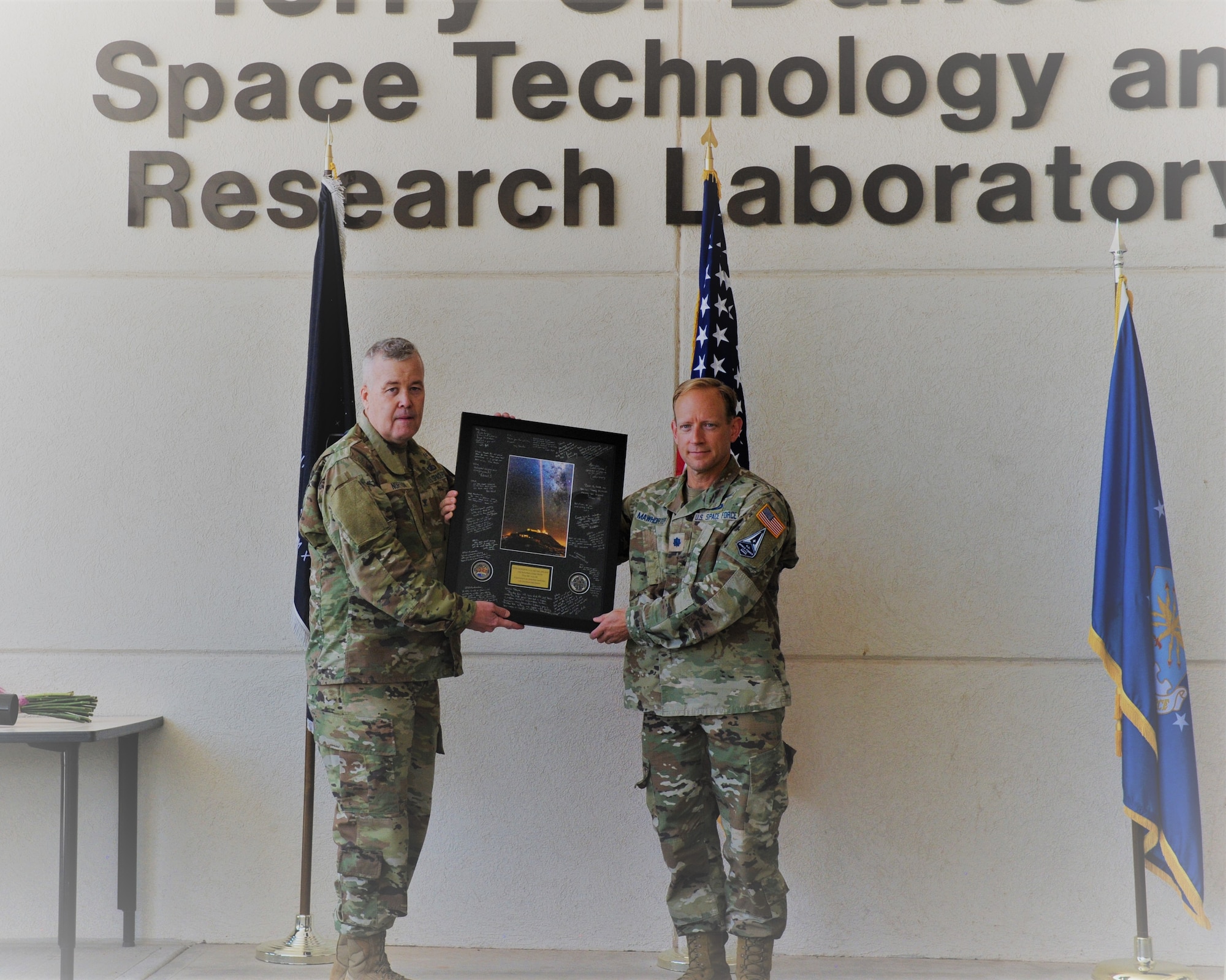 Col. Peter Norton, left, AFRL Space Electro-Optics Division chief presents Lt. Col. Steven Mawhorter a remembrance of the Starfire Optical Range at a transfer of leadership ceremony held at the SOR July 16. Mawhorter departed the SOR, located on Kirtland AFB, N.M. to take a position as the Space Warfighting Modeling and Simulation lead for the AFRL Space Vehicles Directorate at Kirtland. (U.S. Air Force photo/Capt. Thomas Dickinson)
