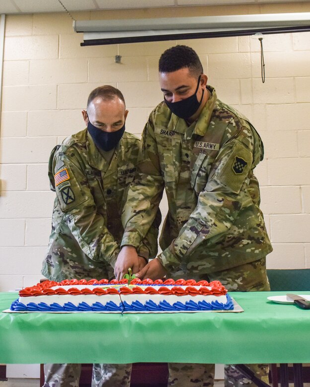 U.S. Army Lt. Col. Steve Blackwell, (left), 99th Readiness Division Deputy Command Chaplain, and U.S. Army Specialist Sharp, (right), cut the Army Chaplain Corps birthday cake at Joint Base McGuire-Dix-Lakehurst, N.J., July 29, 2021. Traditionally the oldest and youngest members of the team have the honor of making the first cut.