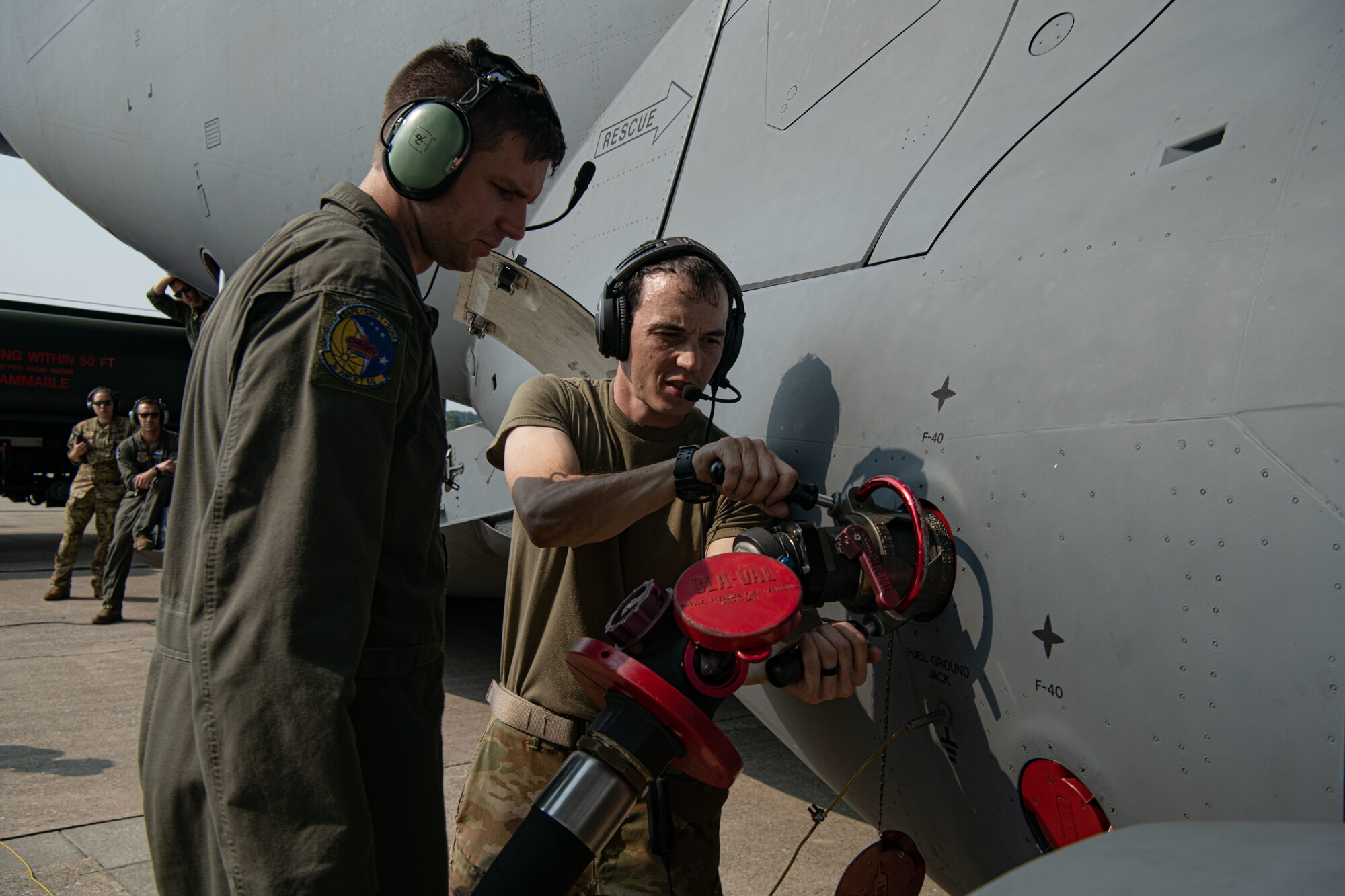 Staff Sgts. Morgen Sindelar and Matthew Van Compernolle, both 3rd Airlift Squadron loadmasters, attach a fuel service hose to a C-17 Globemaster III on Dover Air Force Base, Delaware, July 30, 2021. Airmen from the 436th Logistics Readiness Squadron petroleum, oil and lubricant flight and the 3rd AS performed the first C-17 wet wing defuel procedure at Dover AFB. (U.S. Air Force photo by Senior Airman Marco A. Gomez)