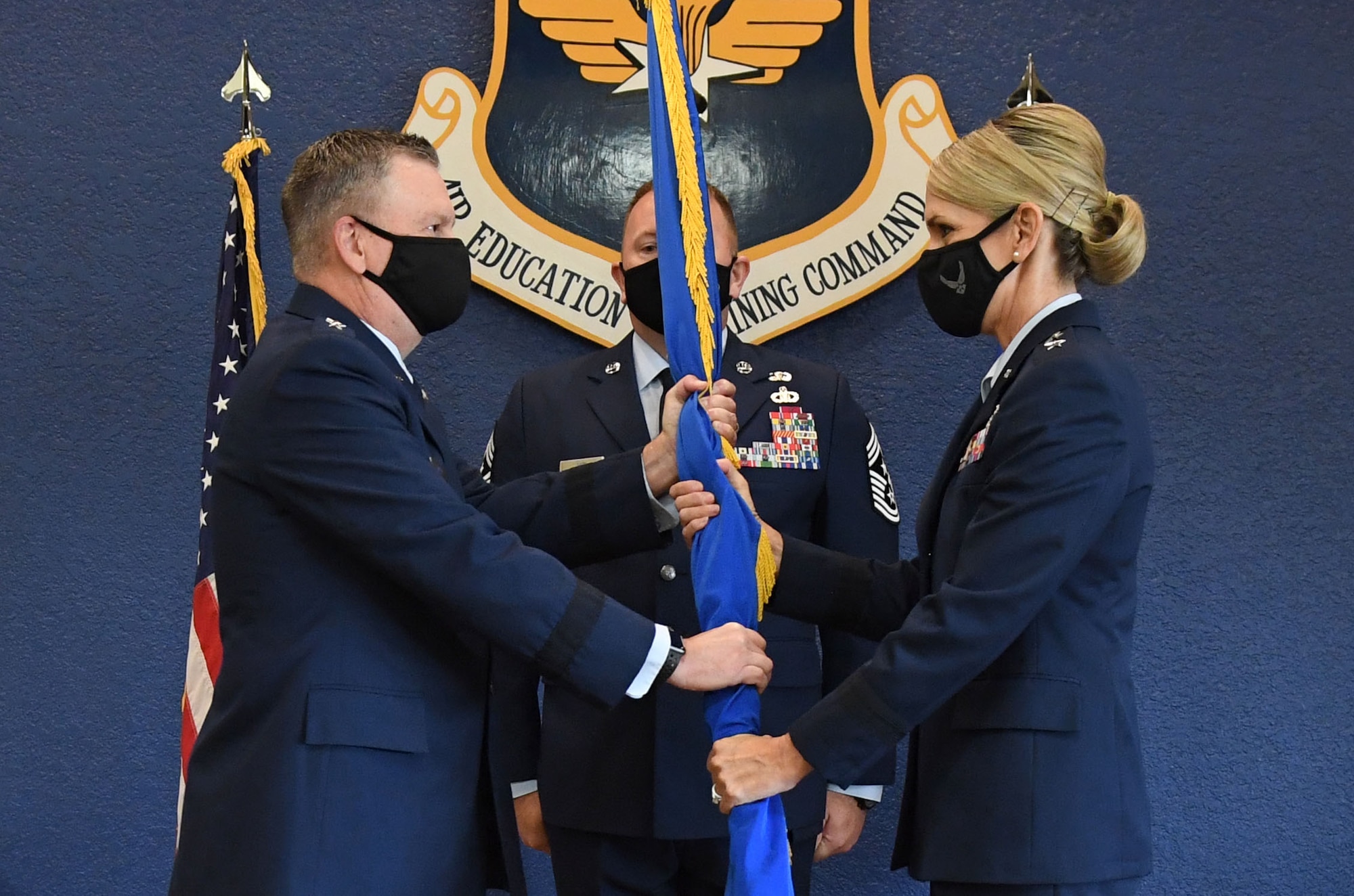 U.S. Air Force Lt. Gen. Brad Webb, commander of Air Education and Training Command, presents the guidon to Maj. Gen. Michele Edmondson, Second Air Force commander, during the Second Air Force change of command ceremony inside the Bay Breeze Event Center at Keesler Air Force Base, Mississippi, July 30, 2021. The ceremony is a symbol of command being exchanged from one commander to the next. Edmondson took command of the Second Air Force from Maj. Gen. Andrea Tullos. (U.S. Air Force photo by Kemberly Groue)