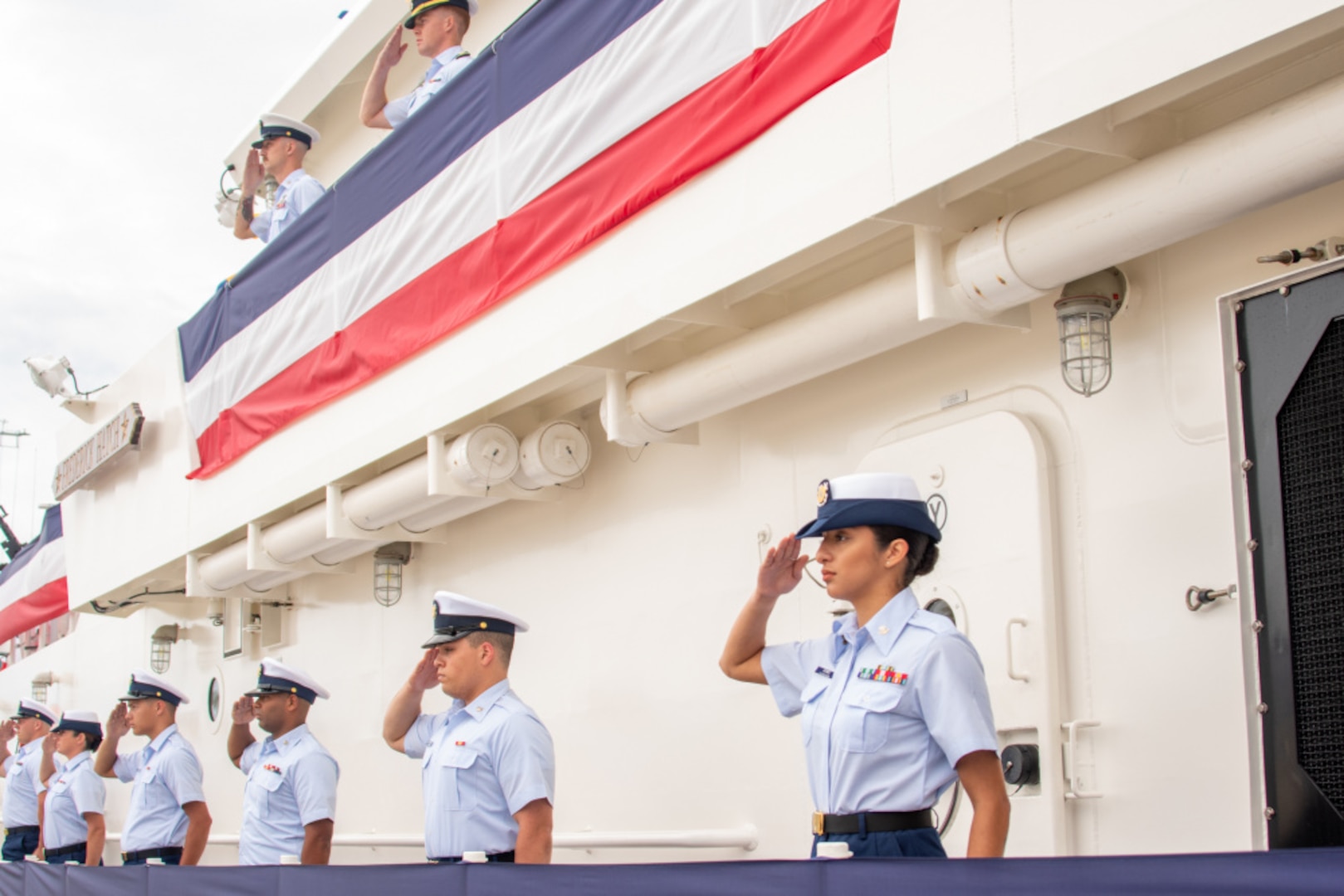 The crew of Coast Guard Cutter Fredrick Hatch salute during a rare triple-commissioning ceremony at Coast Guard Sector Guam July 29, 2021. During the ceremony, Coast Guard Cutters Myrtle Hazard, Oliver Henry and Fredrick Hatch were commissioned.