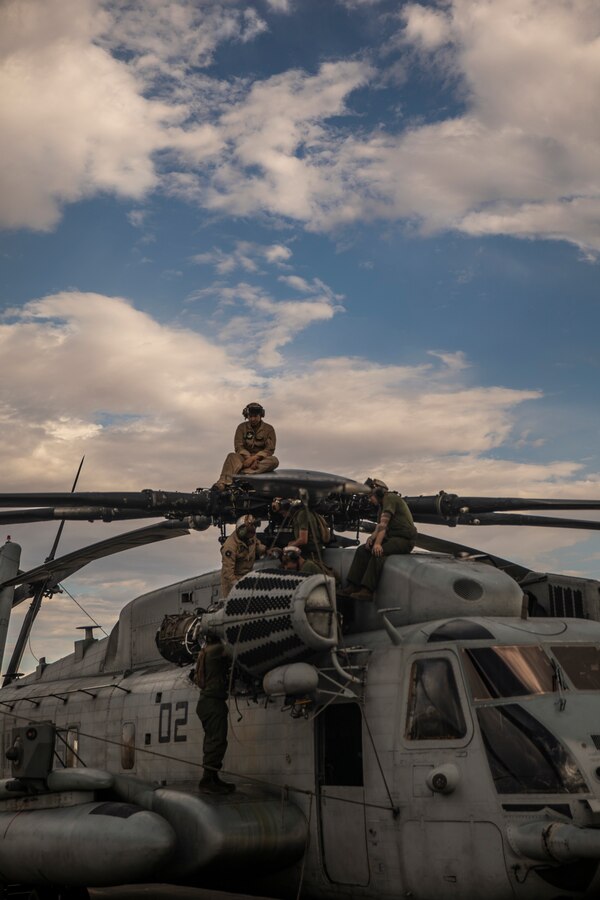 Marines with Marine Heavy Helicopter Squadron (HMH) 772 perform maintenance on a CH-53E Super Stallion helicopter during Integrated Training Exercise (ITX) 4-21 at Marine Corps Air Ground Combat Center, Twentynine Palms, California on July 28, 2021. HMH-772 is supporting Marine Air Ground Task Force 25 as part of the Aviation Combat Element during ITX, providing troop transport and heavy lift capabilities. (U.S. Marine Corps photo by Lance Cpl. Samwel Tabancay)