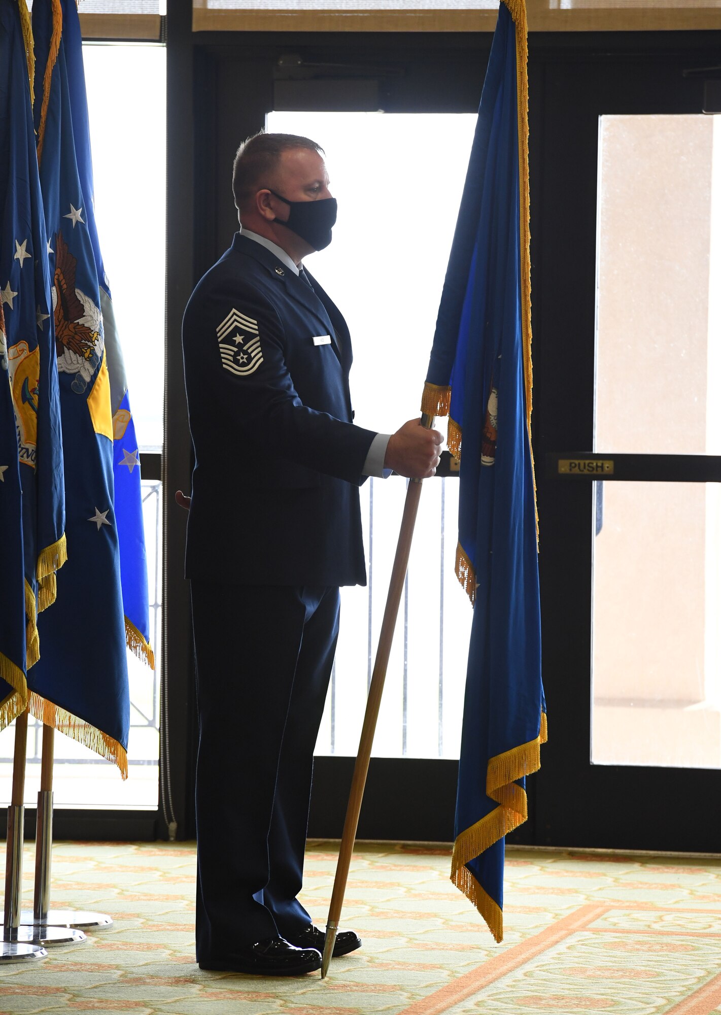 U.S. Air Force Chief Master Sgt. Adam Vizi, Second Air Force command chief holds the guidon during the Second Air Force change of command ceremony inside the Bay Breeze Event Center at Keesler Air Force Base, Mississippi, July 30, 2021. The ceremony is a symbol of command being exchanged from one commander to the next. Maj. Gen. Andrea Tullos relinquished command of the Second Air Force to Maj. Gen. Michele Edmondson. (U.S. Air Force photo by Kemberly Groue)