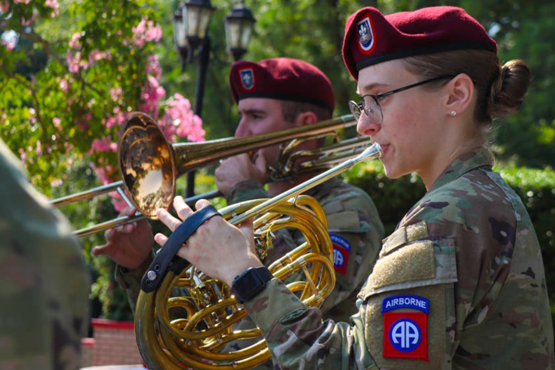Two soldiers play instruments.
