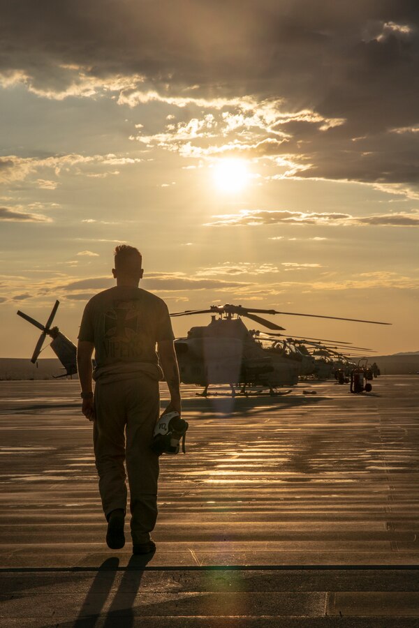 A Marine with Marine Light Attack Helicopter Squadron 773 approaches the flight line during Integrated Training Exercise (ITX) 4-21 at Marine Corps Air Ground Combat Center, Twentynine Palms, California on July 28, 2021. HMLA-773 is supporting Marine Air Ground Task Force 25 as part of the Aviation Combat Element during ITX, providing close air support and deep air support to the Ground Combat Element. (U.S. Marine Corps by photo Sgt. JVonnta Taylor)
