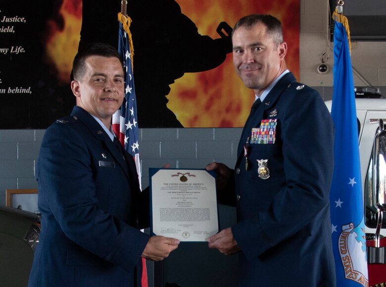 U.S. Air Force Col. David Wilson, 21st Mission Support Group commander, left, presents U.S. Air Force Lt. Col. Timothy Fryar, 21st Civil Engineer Squadron outgoing commander, with the Meritorious Service Medal at Peterson Space Force Base, Colorado, July 29, 2021. Fryar received the medal for his performance of outstanding service as commander of the 21st CES. (U.S. Space Force photo by Airman Aaron Edwards)