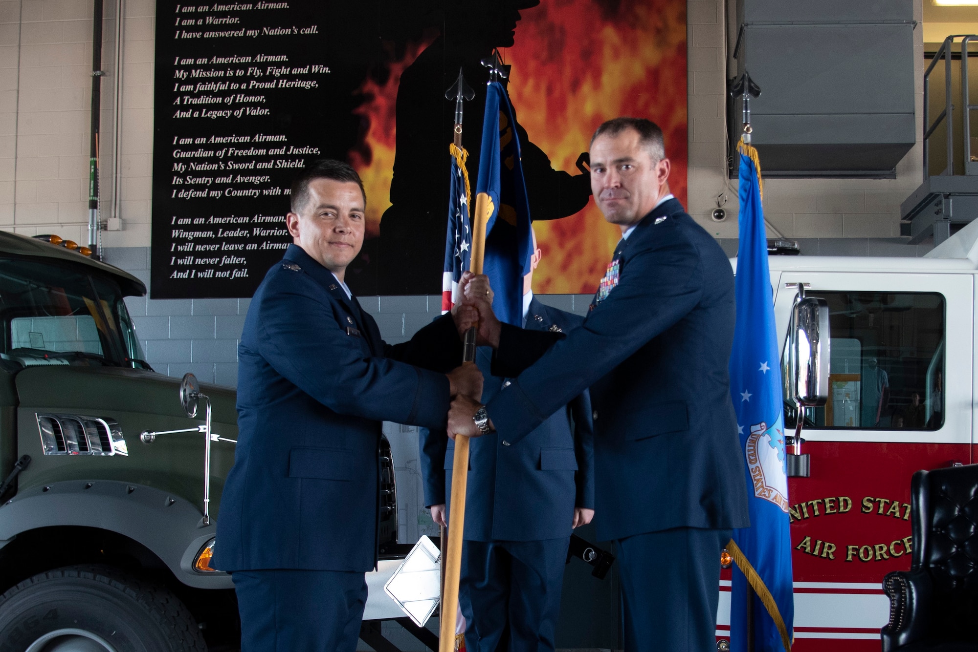 U.S. Air Force Lt. Col. Timothy Fryar, 21st Civil Engineer Squadron outgoing commander, right, relinquishes command during the squadron’s change of command ceremony at Peterson Space Force Base, Colorado, July 29, 2021. The 21st CES prepares military personnel for worldwide mobility contingencies. On Peterson SFB, they maintain, repair and construct essential facilities and utility infrastructure systems to include electrical power systems, water and natural gas distribution systems, base roads and pavements. Fire protection and prevention, as well as environmental and family housing programs are also managed by the 21st CES Airmen and Federal civilians. (U.S. Space Force photo by Airman Aaron Edwards)