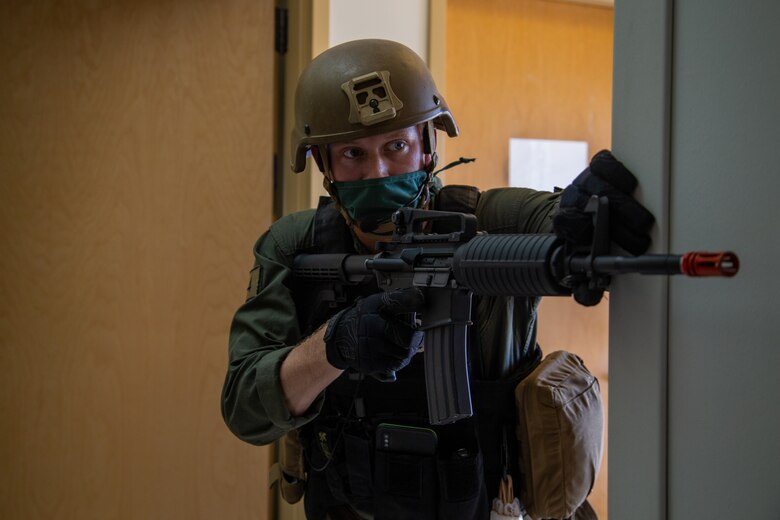 U.S. Marine Corps Cpl. Jonathan D. Moore, an assistant team leader for the Special Reaction Team with the Provost Marshal Office, Headquarters and Headquarters Squadron, provides security during Exercise Desert Fire 2021 at the Naval Branch Health Clinic on Marine Corps Air Station Yuma, Ariz., July 28, 2021. Desert Fire is an active-shooter drill implemented to test, evaluate and improve the response and preparedness of first responders with the air station.  (U.S. Marine Corps photo by Lance Cpl. Gabrielle Sanders)