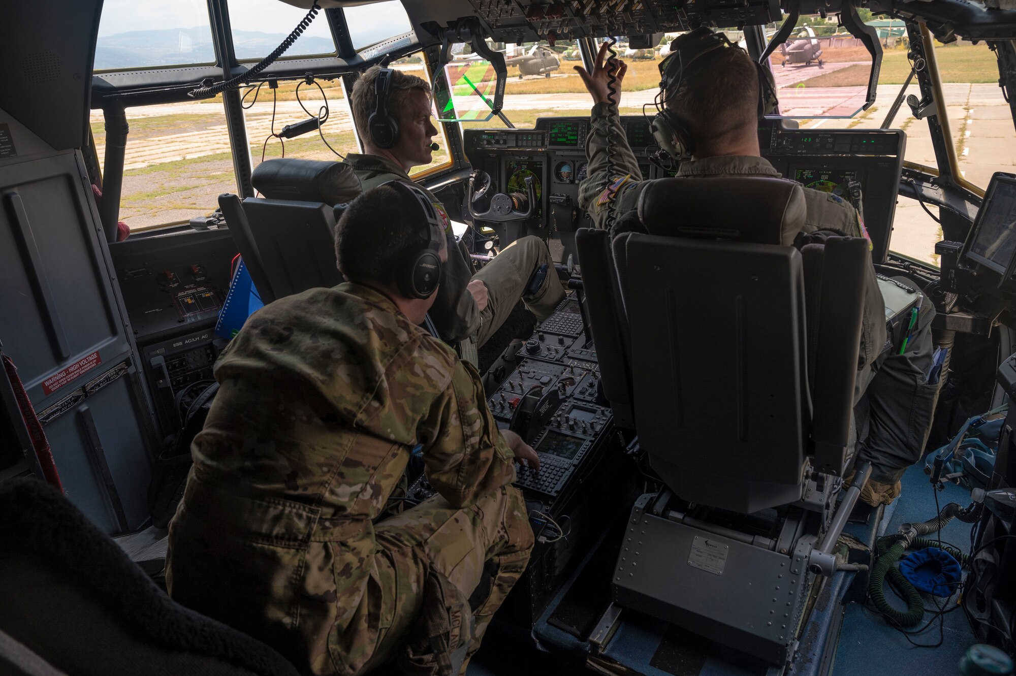 Three U.S. Air Force pilots assigned to the 37th Airlift Squadron conduct pre-flight checks in a C-130J Super Hercules aircraft during exercise Agile Spirit 21