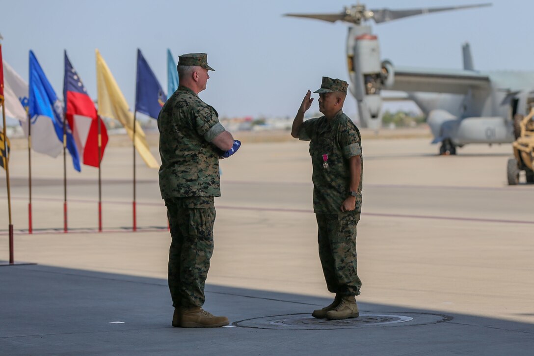 U.S. Marine Corps Sgt. Maj. Larry Buenafe salutes Col. Bryon Sullivan during a change of command ceremony on Marine Corps Air Station Yuma, Ariz., June 15, 2021. Sgt. Maj. Buenafe was relieved of his duty as Marine Operational Test and Evaluation Squadron 1 sergeant major by Sgt. Maj. Frank Gratacos. (U.S. Marine Corps photo by Lance Cpl. Gabrielle Sanders)