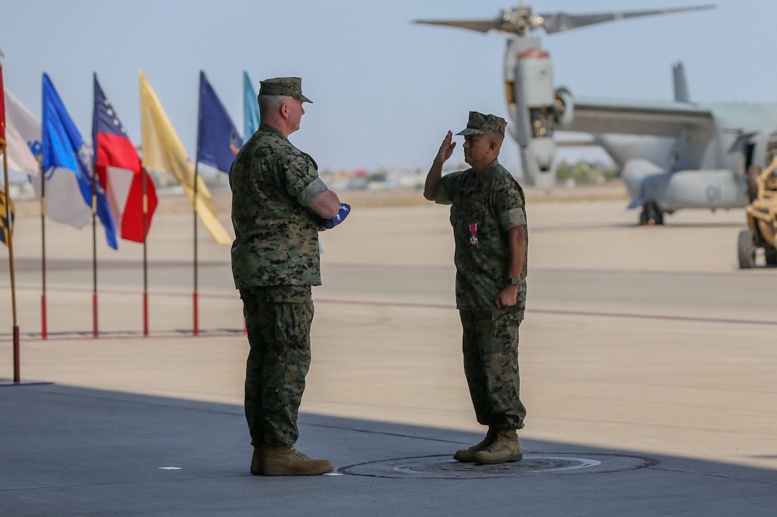 U.S. Marine Corps Sgt. Maj. Larry Buenafe salutes Col. Bryon Sullivan during a change of command ceremony on Marine Corps Air Station Yuma, Ariz., June 15, 2021.