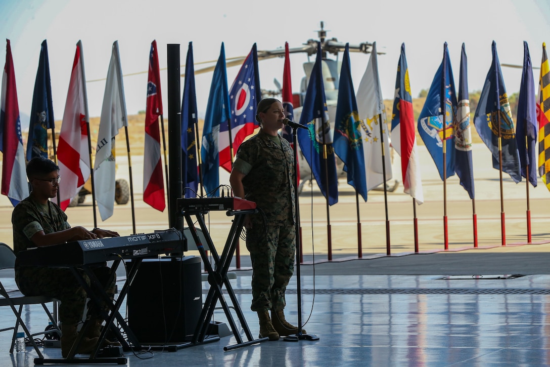 U.S. Marine Corps Cpl. Megan Browning, a musician with Marine Wing Headquarters Squadron 3, 3d Marine Aircraft Wing sings during a change of command ceremony on Marine Corps Air Station Yuma, Ariz., June 15, 2021.