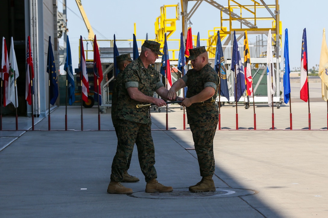 U.S. Marine Corps Col. Bryon Sullivan passes the sword to Sgt. Maj. Frank Gratacos during a change of command ceremony on Marine Corps Air Station Yuma, Ariz., June 15, 2021. The passing of the sword symbolizes the relief of duty from Sgt. Maj. Larry Buenafe as Marine Operational Test and Evaluation Squadron 1 sergeant major by Sgt. Maj. Gratacos. (U.S. Marine Corps photo by Lance Cpl. Gabrielle Sanders)