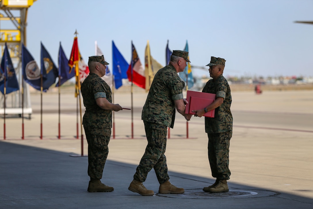 U.S. Marine Corps Sgt. Maj. Larry Buenafe receives awards from Col. Bryon Sullivan during a change of command ceremony on Marine Corps Air Station Yuma, Ariz., June 15, 2021.