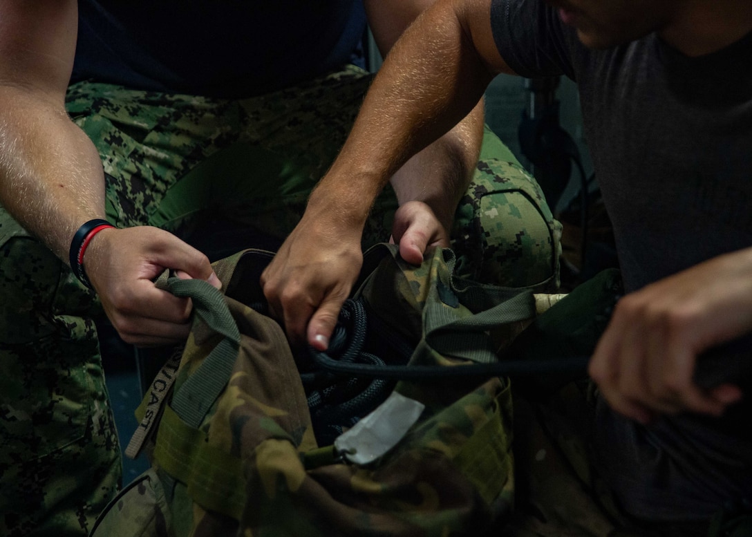 210730-N-YQ181-1113 ARABIAN SEA (July 30, 2021) – An Explosive Ordnance Disposal Technician, assigned to Explosive Ordnance Disposal Mobile Unit (EODMU) 5, prepares equipment in response to a call for assistance from a vessel in distress in the Arabian Sea, July 30. EODMU5 is attached to Commander, Task Force 50, deployed to the U.S. 5th Fleet area of operations in support of naval operations to ensure maritime stability and security in the Central Region, connecting the Mediterranean and Pacific through the western Indian Ocean and three strategic choke points. (U.S. Navy photo by Mass Communication Specialist 3rd Class Askia Collins)