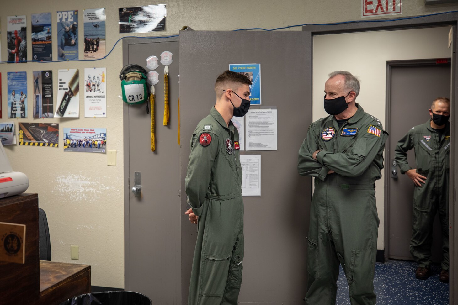 Vice Chief of Naval Operations Adm. Bill Lescher, center, speaks with Lt. Scott Davids, a pilot assigned to the "Airwolves" of Helicopter Maritime Strike Squadron (HSM) 40 in their maintenance control office at Naval Station Mayport, Florida.