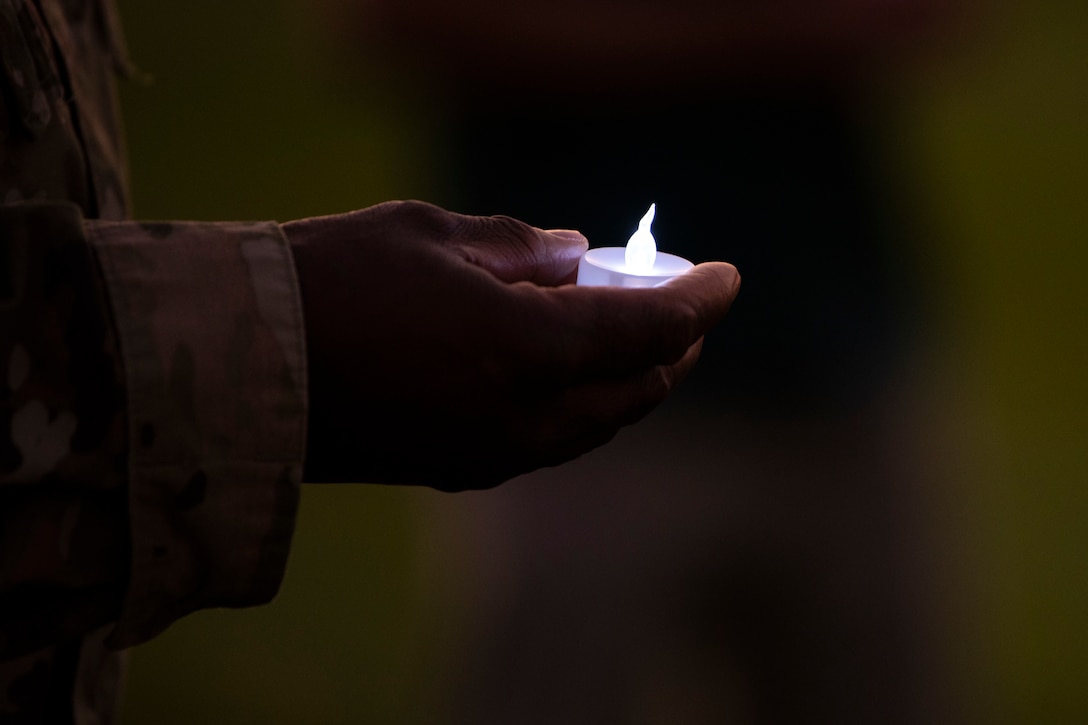 The arm of an ariman is seen holding a small candle.