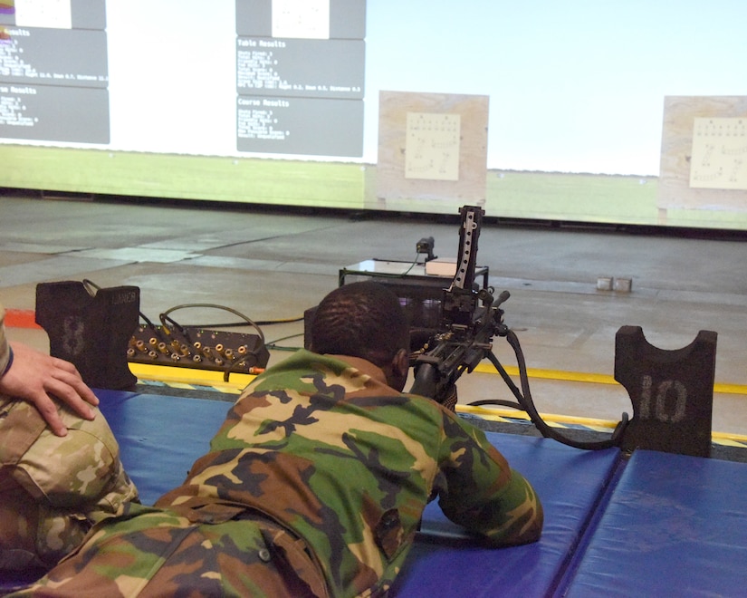 Soldiers with the Michigan National Guard train members of the Armed Forces of Liberia on weapons systems using the engagement skills trainer at Camp Grayling Joint Maneuver Training Center, Grayling, Michigan, July 27, 2021. Through the State Partnership Program, Michigan has teamed with Latvia and Liberia.