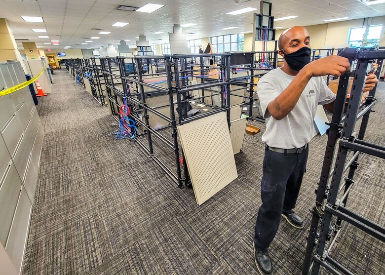 Jerral O’Connor, Wittigs Office Interiors, disassembles cubicles in Bay 4 of the Air Force Installation and Mission Support Center headquarters building, San Antonio, Texas, July 29, 2021. Cubicles are being removed to make room for café-style seating. The work is part of AFIMSC’s Office of the Future initiative to create an office environment that enables flexibility, fosters innovation and collaboration, and improves quality of life and mission effectiveness.