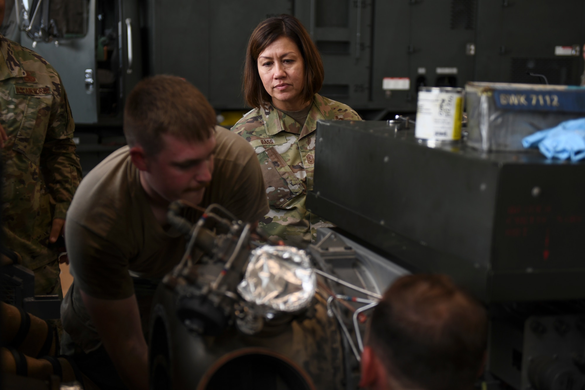 Chief Master Sergeant of the Air Force JoAnne S. Bass watches 55th Logistics Readiness Squadron Airmen work on a generator