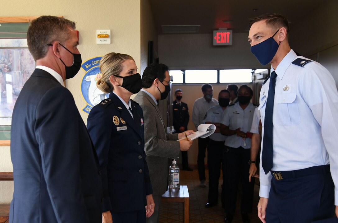 U.S. Air Force Lt. Col. Kevin Brockler, 335th Training Squadron commander, greets Maj. Gen. Michele Edmondson, Second Air Force commander, and her husband, Dave McGowan, during a change of command ceremony reception following the Second Air Force change of command ceremony inside the Bay Breeze Event Center at Keesler Air Force Base, Mississippi, July 30, 2021. The ceremony is a symbol of command being exchanged from one commander to the next. Edmondson assumed command of the Second Air Force from Maj. Gen. Andrea Tullos. (U.S. Air Force photo by Kemberly Groue)